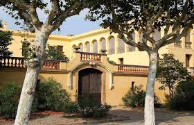 Fontanero Cardedeu: calle tranquila con casas de piedra, fuente histórica y montañas al fondo, emblemático de la ciudad.